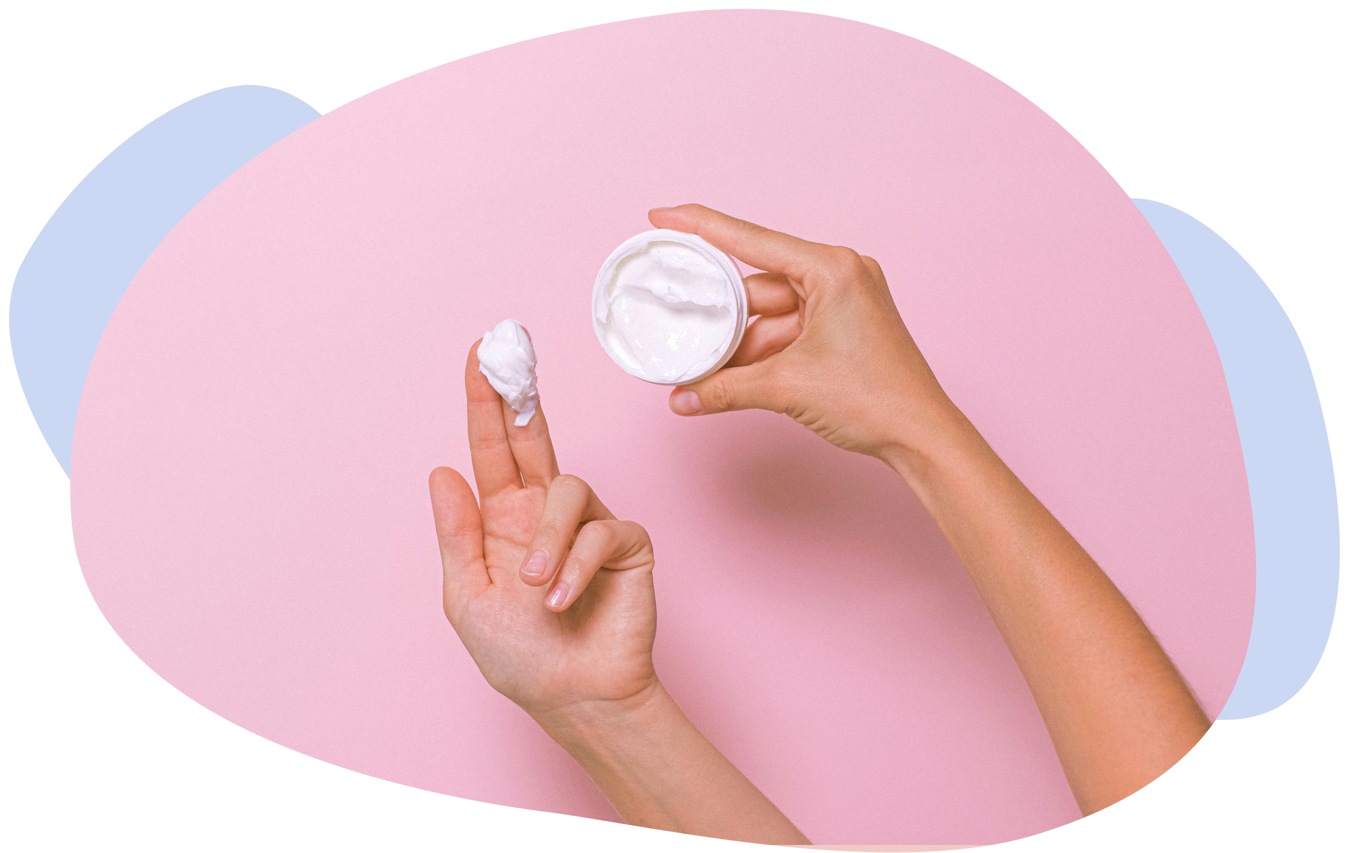 Close-up of hands scooping cream from a jar on a pastel background.