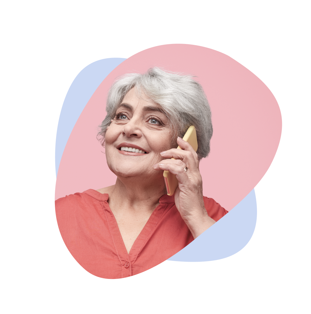 Elderly woman with gray hair speaks on the phone.