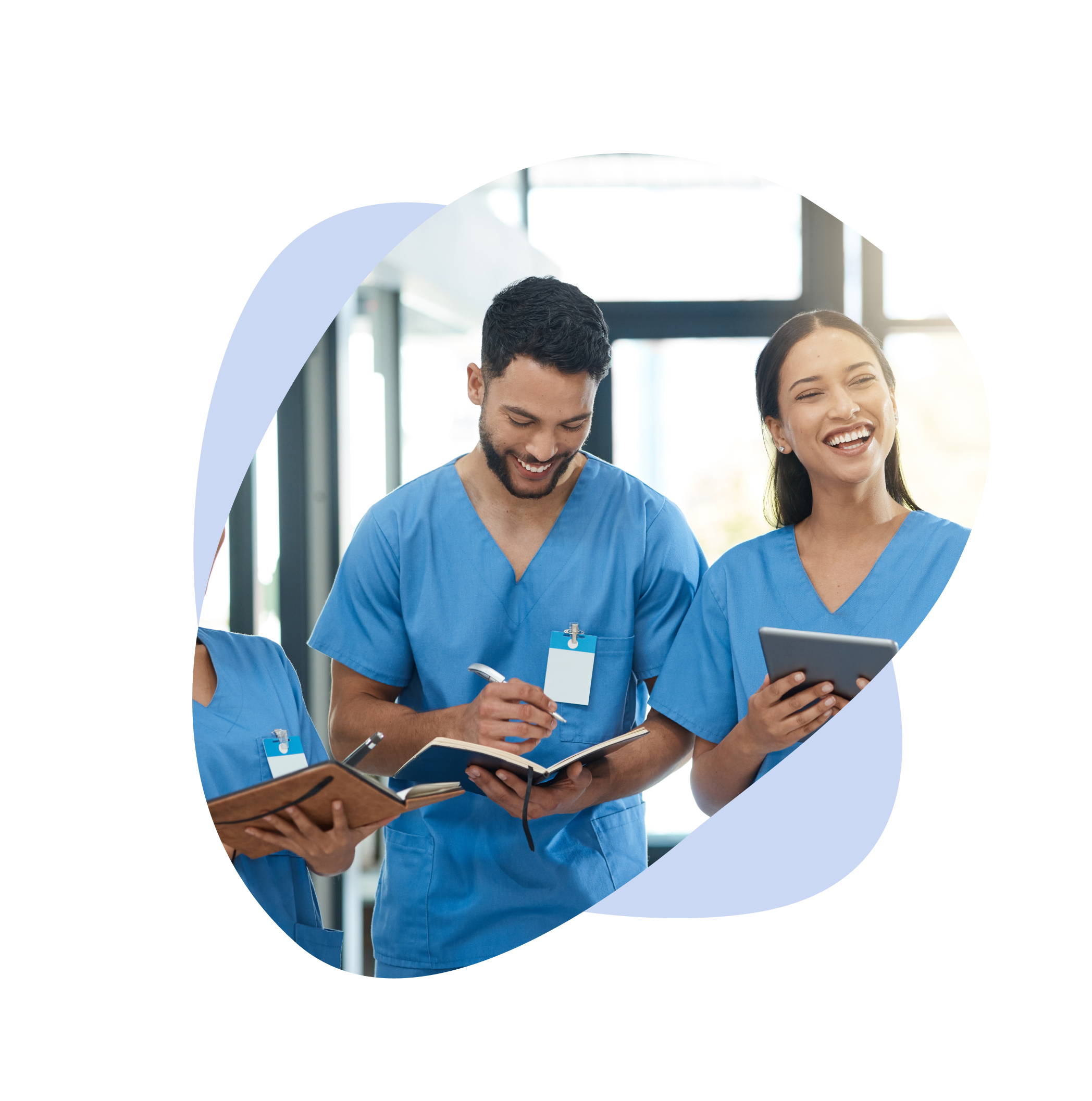 Team of medics in blue scrubs laugh and take notes.