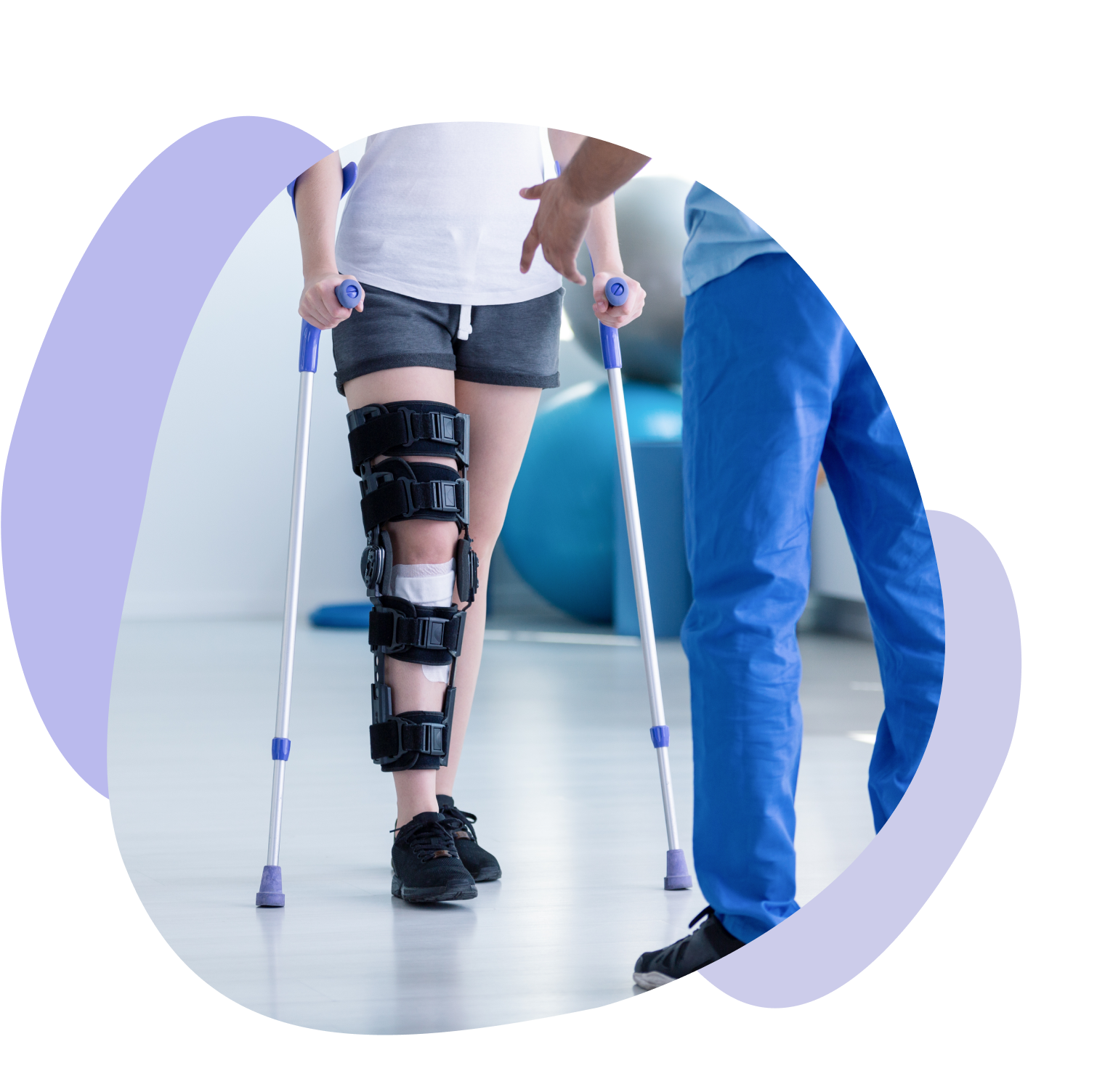 Patient with a leg brace walks on crutches assisted by a therapist during rehabilitation.