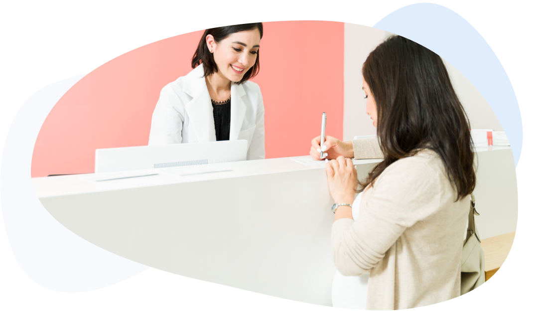 Expectant mother giving her personal information at the receptionist