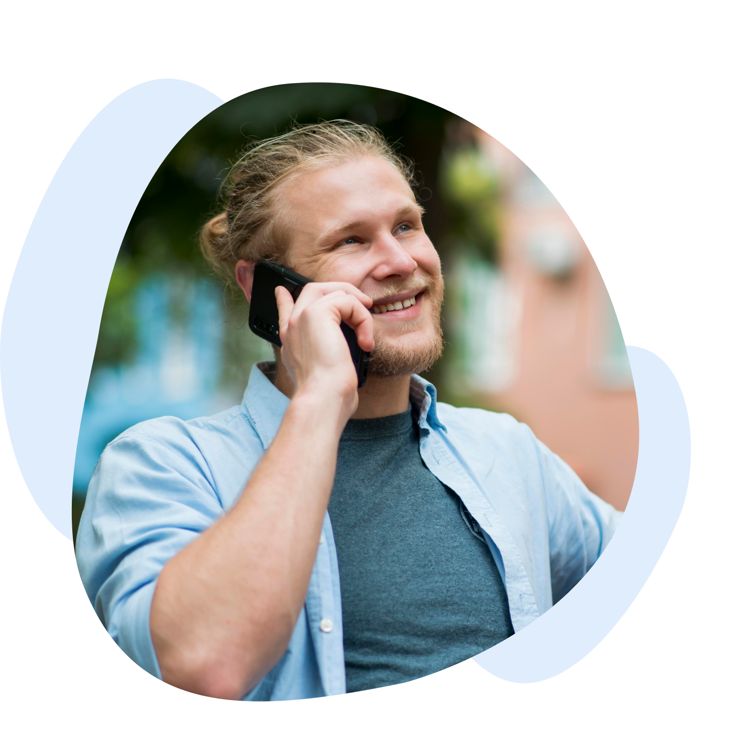 Smiley man taking on smartphone outdoors