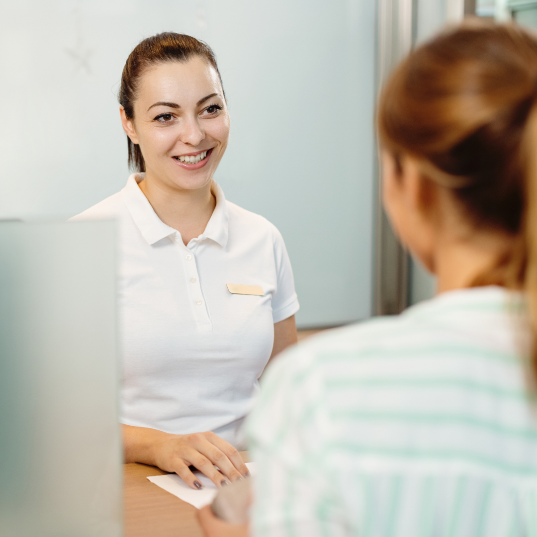 Medical front desk staff talking with a patient