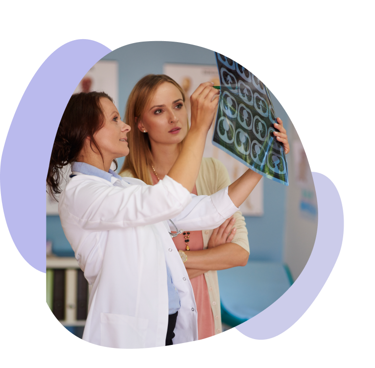 Doctor discussing brain CT scan results with a patient in a medical office